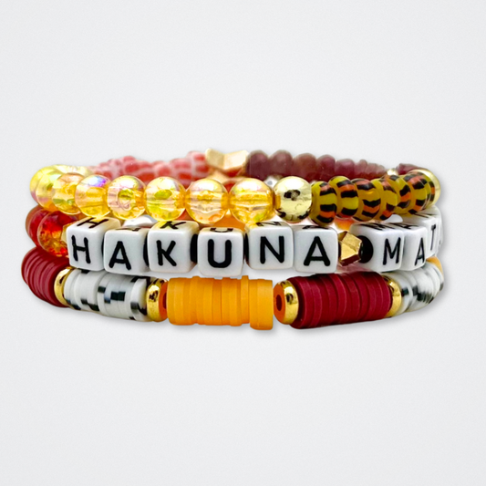 Broadway Stacks SAFARI collection. 3 stretch bracelets included in Stack. Dark reds, yellow, orange, white, black and gold colored beads. Animal print beads as well. Letter beads that spell quotes, Gold star logo bead to remind you that you shine.