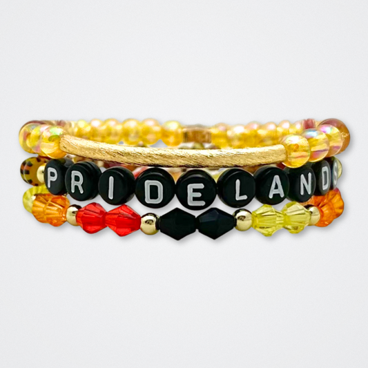 Broadway Stacks SAFARI collection. 3 stretch bracelets included in Stack. Dark reds, yellow, orange, white, black and gold colored beads. Animal print beads as well. Letter beads that spell quotes, Gold star logo bead to remind you that you shine.