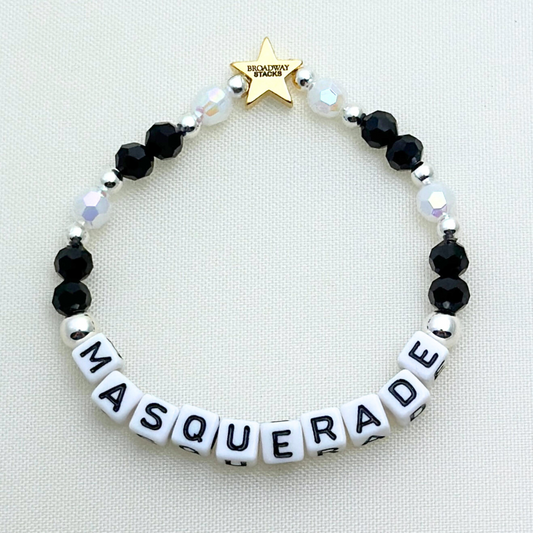 Broadway Stacks MASQUERADE Collection. 4 stretch bracelets included in Stack. Black, white and silver colored beads. Letter beads that spell quotes. Gold star logo bead to remind you that you shine. Phantom of the Opera and Masquerade NYC fans.