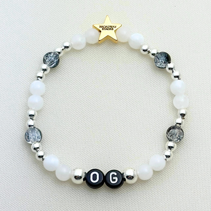 Broadway Stacks MASQUERADE Collection. 4 stretch bracelets included in Stack. Black, white and silver colored beads. Letter beads that spell quotes. Gold star logo bead to remind you that you shine. Phantom of the Opera and Masquerade NYC fans.
