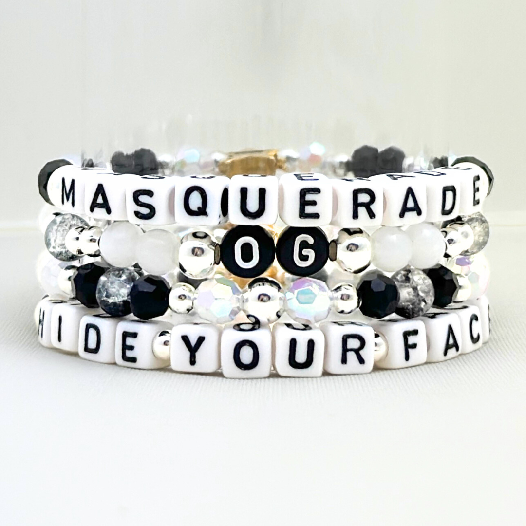Broadway Stacks MASQUERADE Collection. 4 stretch bracelets included in Stack. Black, white and silver colored beads. Letter beads that spell quotes. Gold star logo bead to remind you that you shine. Phantom of the Opera and Masquerade NYC fans.
