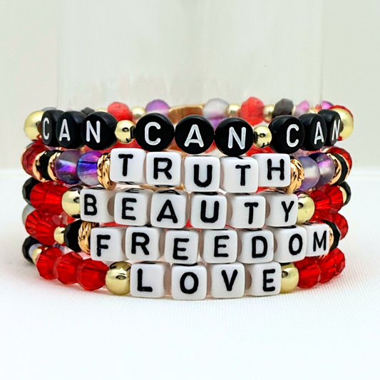 Broadway Stacks RED LIGHT Collection. 5 stretch bracelets included in Stack. Red, purple, black and gold colored beads. Letter beads that spell quotes. Gold star logo bead to remind you that you shine. Moulin Rouge fans. 