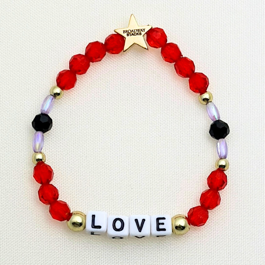 Broadway Stacks RED LIGHT Collection. 5 stretch bracelets included in Stack. Red, purple, black and gold colored beads. Letter beads that spell quotes. Gold star logo bead to remind you that you shine. Moulin Rouge fans. 