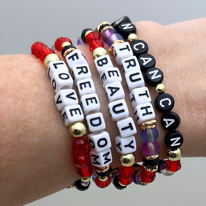 Broadway Stacks RED LIGHT Collection. 5 stretch bracelets included in Stack. Red, purple, black and gold colored beads. Letter beads that spell quotes. Gold star logo bead to remind you that you shine. Moulin Rouge fans. 