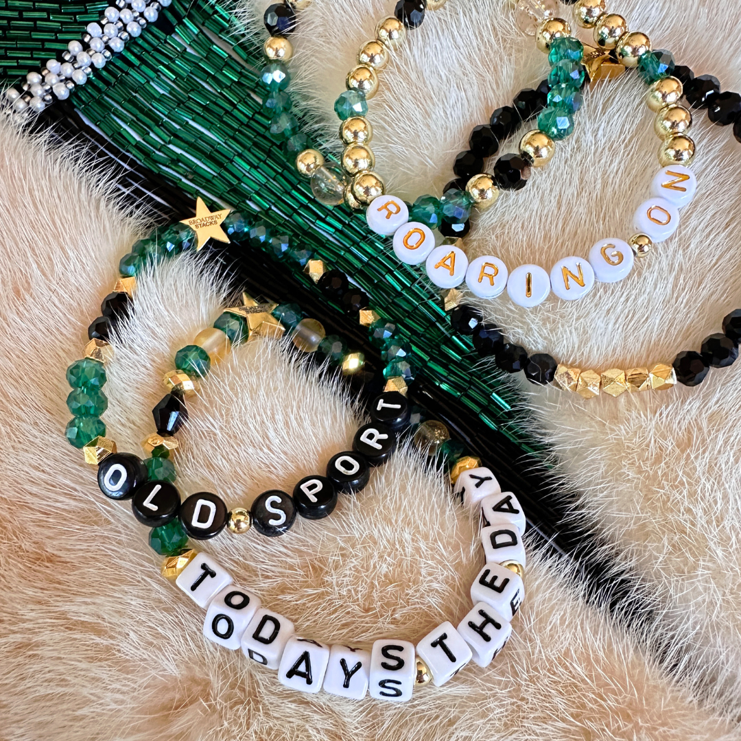 Broadway Stacks NEW MONEY Collection. 5 stretch bracelets included in Stack. Teal, black and gold colored beads. Letter beads that spell quotes. Gold star logo bead to remind you that you shine.