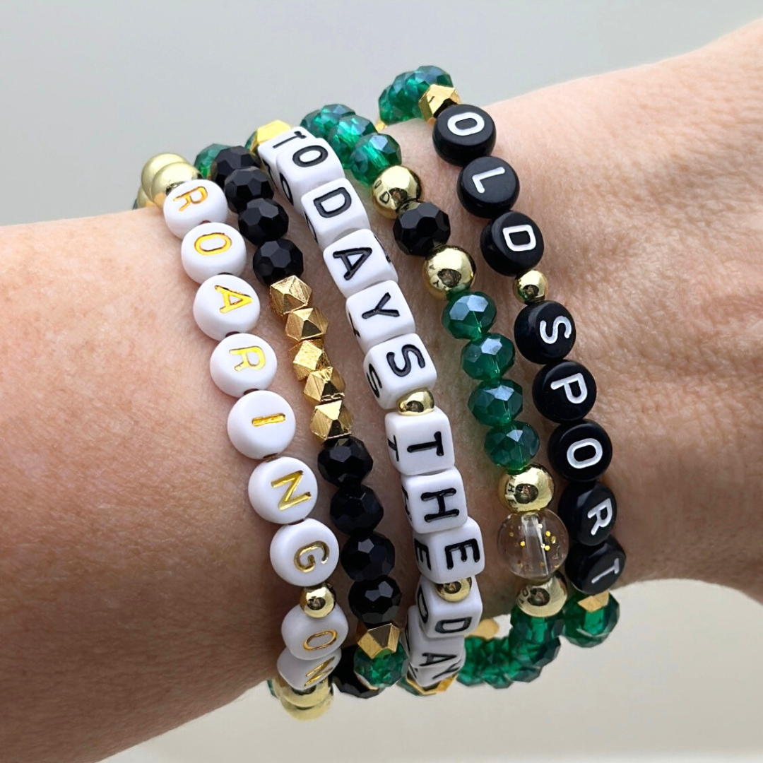 Broadway Stacks NEW MONEY Collection. 5 stretch bracelets included in Stack. Teal, black and gold colored beads. Letter beads that spell quotes. Gold star logo bead to remind you that you shine.