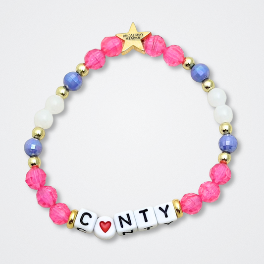 Broadway Stacks POTUS collection. 3 stretch bracelets included in Stack. Pinks, white, blue, golds and black colored beads. Letter beads that spell show quotes. Broadway Stacks gold star logo bead to remind you that You Shine. POTUS play fans.