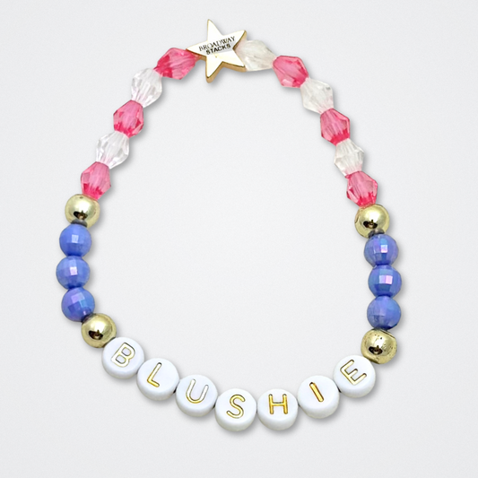 Broadway Stacks POTUS collection. 3 stretch bracelets included in Stack. Pinks, white, blue, golds and black colored beads. Letter beads that spell show quotes. Broadway Stacks gold star logo bead to remind you that You Shine. POTUS play fans.