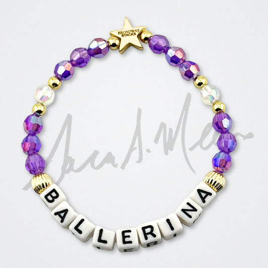 Broadway Stacks Special Edition Sara Mearns ROCKSTAR Bracelet Collection. 5 stretch bracelets included in Stack. Purple, clear, white, black and gold colored beads. Letter beads that spell quotes. Gold star logo bead to remind you that you shine. Sara Mearns and Ballet fans.