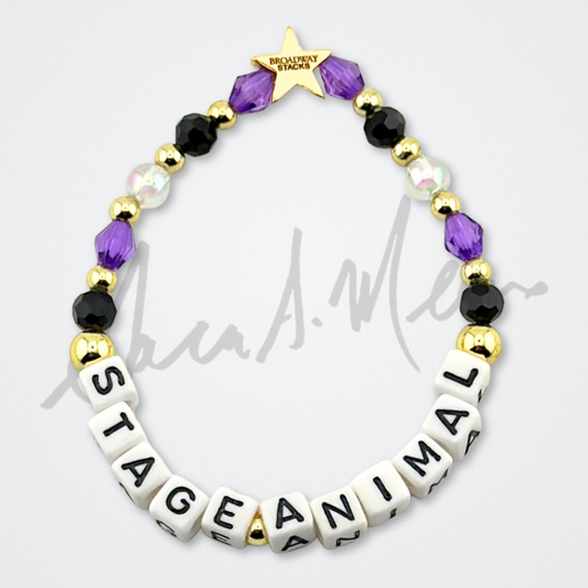 Broadway Stacks Special Edition Sara Mearns ROCKSTAR Bracelet Collection. 5 stretch bracelets included in Stack. Purple, clear, white, black and gold colored beads. Letter beads that spell quotes. Gold star logo bead to remind you that you shine. Sara Mearns and Ballet fans.