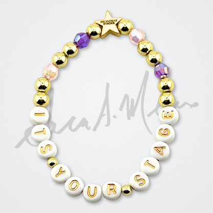 Broadway Stacks Special Edition Sara Mearns STAGE Bracelet Collection. 5 stretch bracelets included in Stack. Purple, pink, clear, white, glitter and gold colored beads. Letter beads that spell quotes. Gold star logo bead to remind you that you shine. Sara Mearns and Ballet fans.