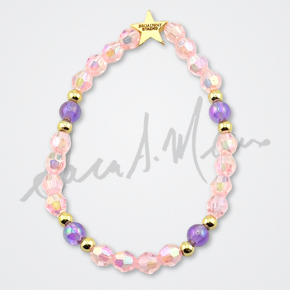 Broadway Stacks Special Edition Sara Mearns STAGE Bracelet Collection. 5 stretch bracelets included in Stack. Purple, pink, clear, white, glitter and gold colored beads. Letter beads that spell quotes. Gold star logo bead to remind you that you shine. Sara Mearns and Ballet fans.