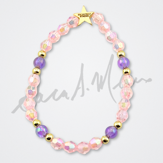 Broadway Stacks Special Edition Sara Mearns STAGE Bracelet Collection. 5 stretch bracelets included in Stack. Purple, pink, clear, white, glitter and gold colored beads. Letter beads that spell quotes. Gold star logo bead to remind you that you shine. Sara Mearns and Ballet fans.