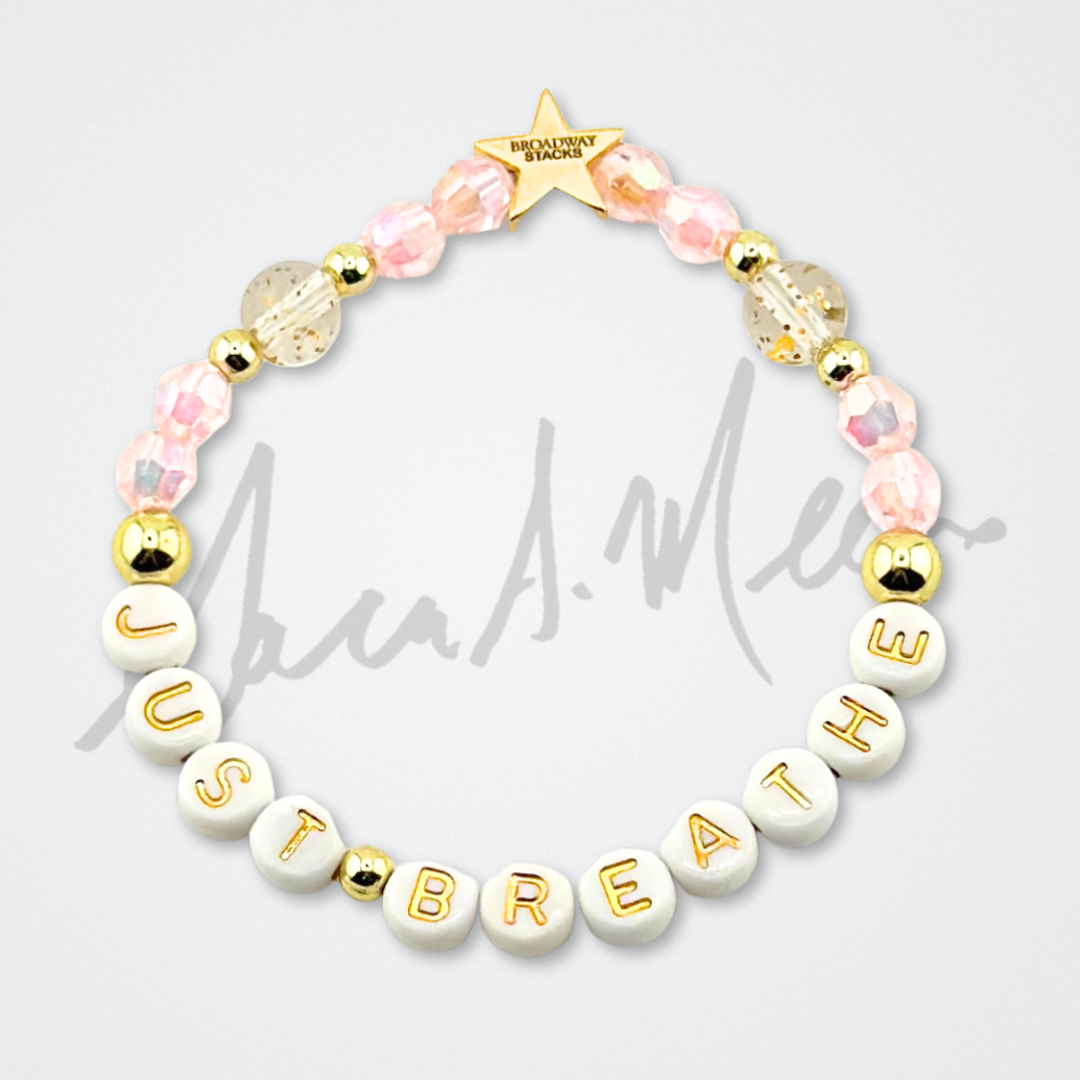 Broadway Stacks Special Edition Sara Mearns STAGE Bracelet Collection. 5 stretch bracelets included in Stack. Purple, pink, clear, white, glitter and gold colored beads. Letter beads that spell quotes. Gold star logo bead to remind you that you shine. Sara Mearns and Ballet fans.