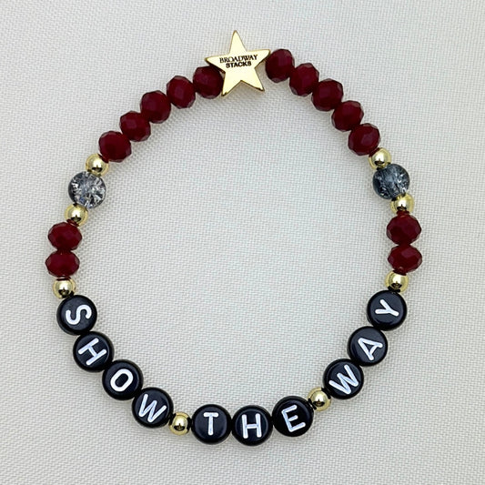 Broadway Stacks Underworld collection. 5 stretch bracelets included in Stack. Red, garnet, black and gold colored beads. Letter beads that spell quotes. Gold star logo bead to remind you that you shine.