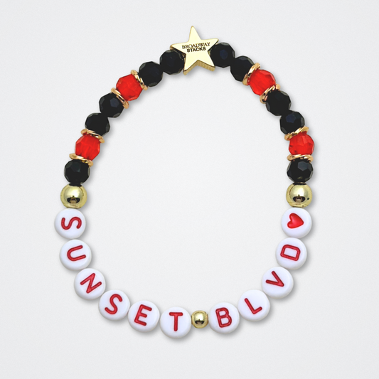 Broadway Stacks CLOSE-UP Collection. 6 stretch bracelets included in Stack. Red, black and gold colored beads. Letter beads that spell quotes. Gold star logo bead to remind you that you shine. Sunset Blvd fans. 