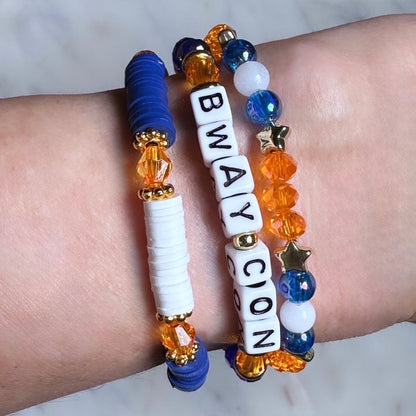 Broadway Stacks BroadwayCon 2024 Stack bracelets. 3 stretch bracelets. Blue, orange, white and gold colored beads. Letter beads that spell Bway Con. All have star logo bead.