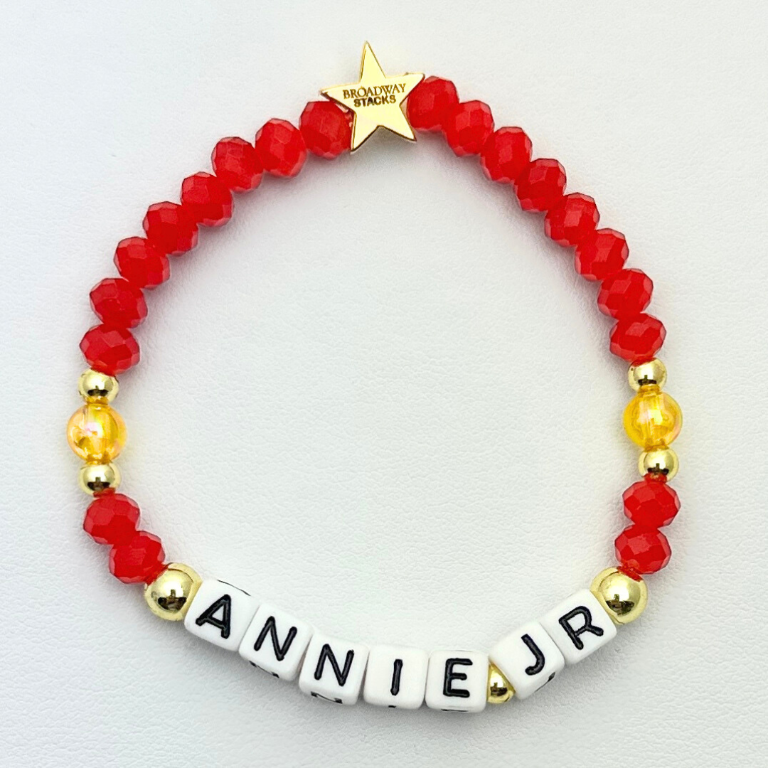 Town Theatre - Annie Jr Limited Edition Bracelet Fundraiser. 1 stretch bracelet. Red, yellow and gold colored beads. Letter beads that spell Annie Jr.