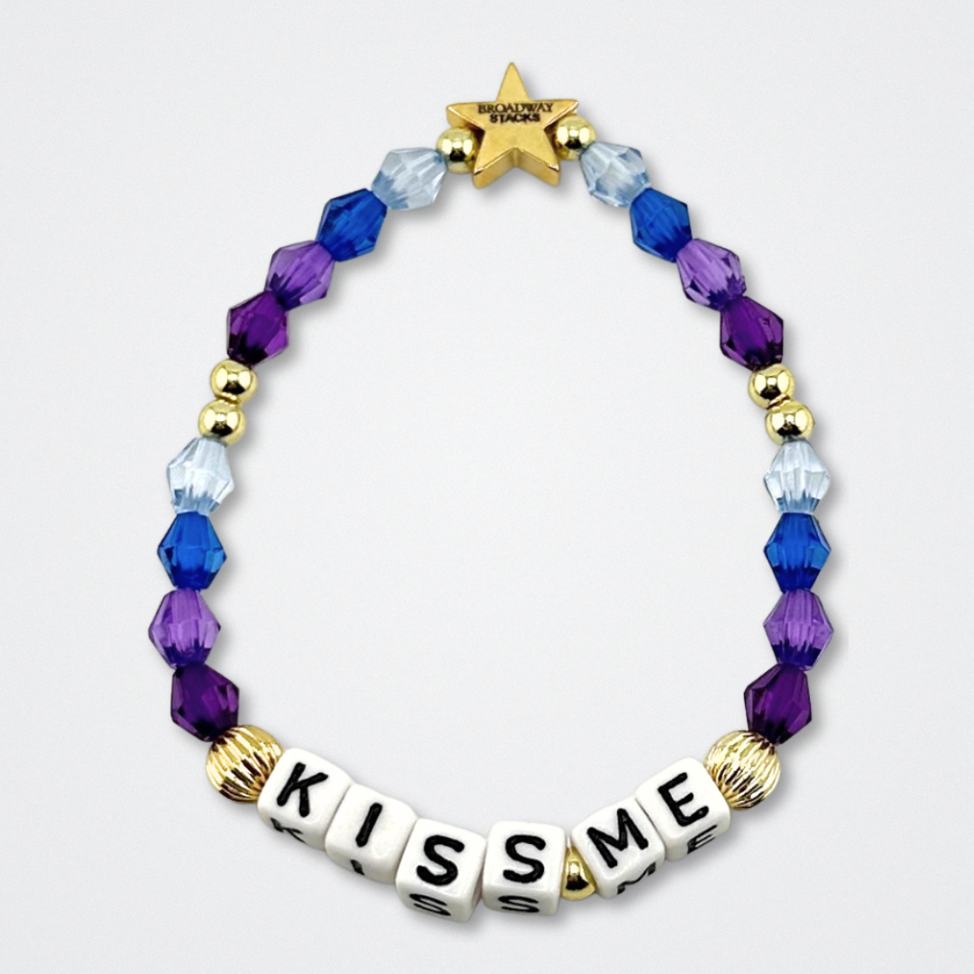 Broadway Stacks theatre-themed bracelet inspired by The Notebook Musical. Quote says KISS ME with blue and purple beads on a gray background. Signature star bead to remind you that You Shine!