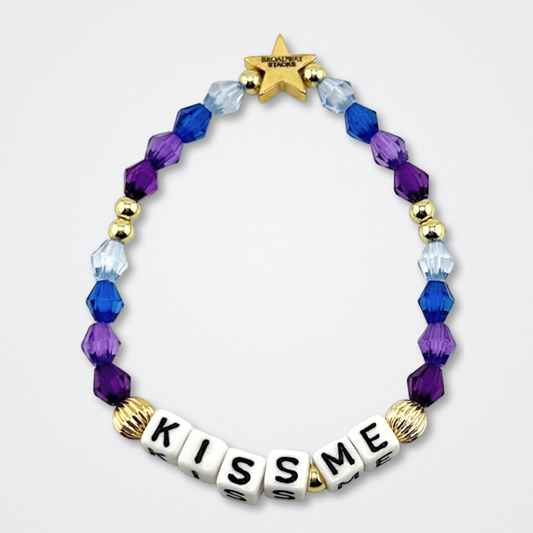 Broadway Stacks theatre-themed bracelet inspired by The Notebook Musical. Quote says KISS ME with blue and purple beads on a gray background. Signature star bead to remind you that You Shine!