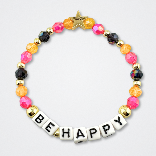 Broadway Stacks CAKE Collection. Be Happy bracelet with yellow, pink black and gold colored beads. Letter beads that spell quote. Star logo bead to remind you that you shine. Two Strangers Carry a Cake Across New York fans.