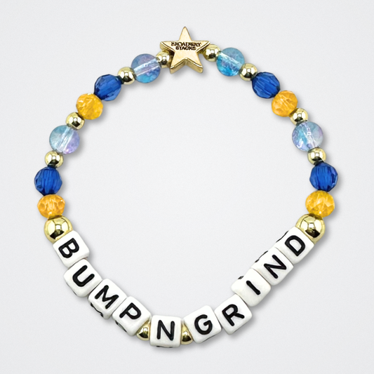 Broadway Stacks CAKE Collection. Bump N Grind bracelet with dark & light blue, yellow and gold colored beads. Letter beads that spell quote from the Coffee Shop. Star logo bead to remind you that you shine. Two Strangers Carry a Cake Across New York fans.