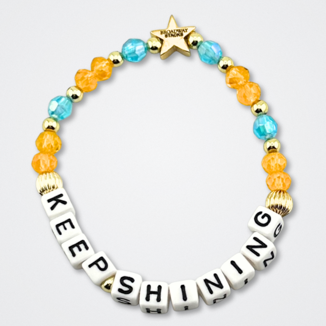 Broadway Stacks BETTER TOGETHER Collection. 5 stretch bracelets included in Stack. Black, white, red, blue, orange, yellow and gold colored beads. Letter beads that spell quotes. Star logo bead to remind you that you shine. Beaches the Musical fans.