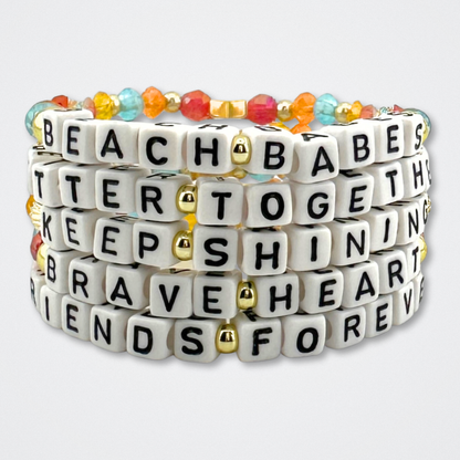 Broadway Stacks BETTER TOGETHER Collection. 5 stretch bracelets included in Stack. Black, white, red, blue, orange, yellow and gold colored beads. Letter beads that spell quotes. Star logo bead to remind you that you shine. Beaches the Musical fans.