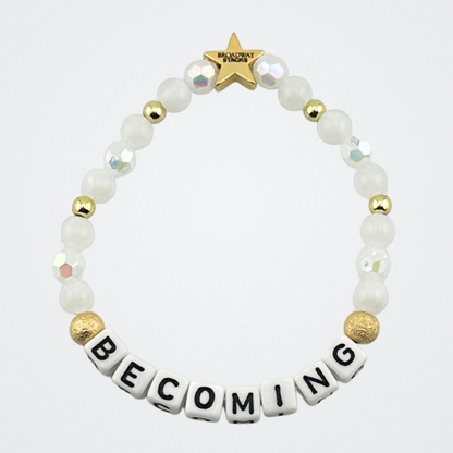 Broadway Stacks Special Edition bracelet. 2026 Focus Word of the Year.  Letter beads that spell Becoming. Based on Pantone Color of the Year Cloud Dancer. Star logo bead to remind you that you shine.