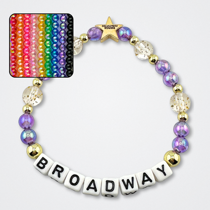 Broadway Stacks BROADWAY bead bracelet displayed on a gray background. Letter beads spell out quote. Signature star bead to remind you: YOU SHINE! Small square showing 9 different colors available. 