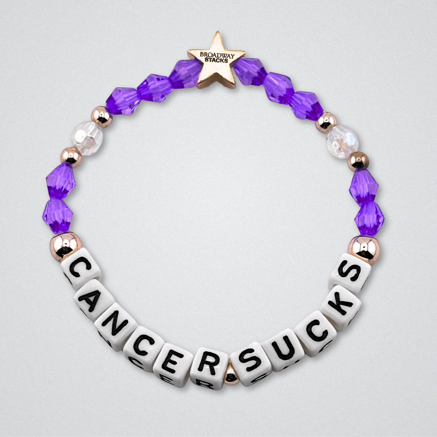 Broadway Stacks Special Edition bracelet. Red, pink, orange, yellow, green, blue. purple, white and gold beads. Letter beads that spell Cancer Sucks. Helping the Broadway Husbands and their fight with Lymphoma cancer. Star logo bead to remind you that you shine.