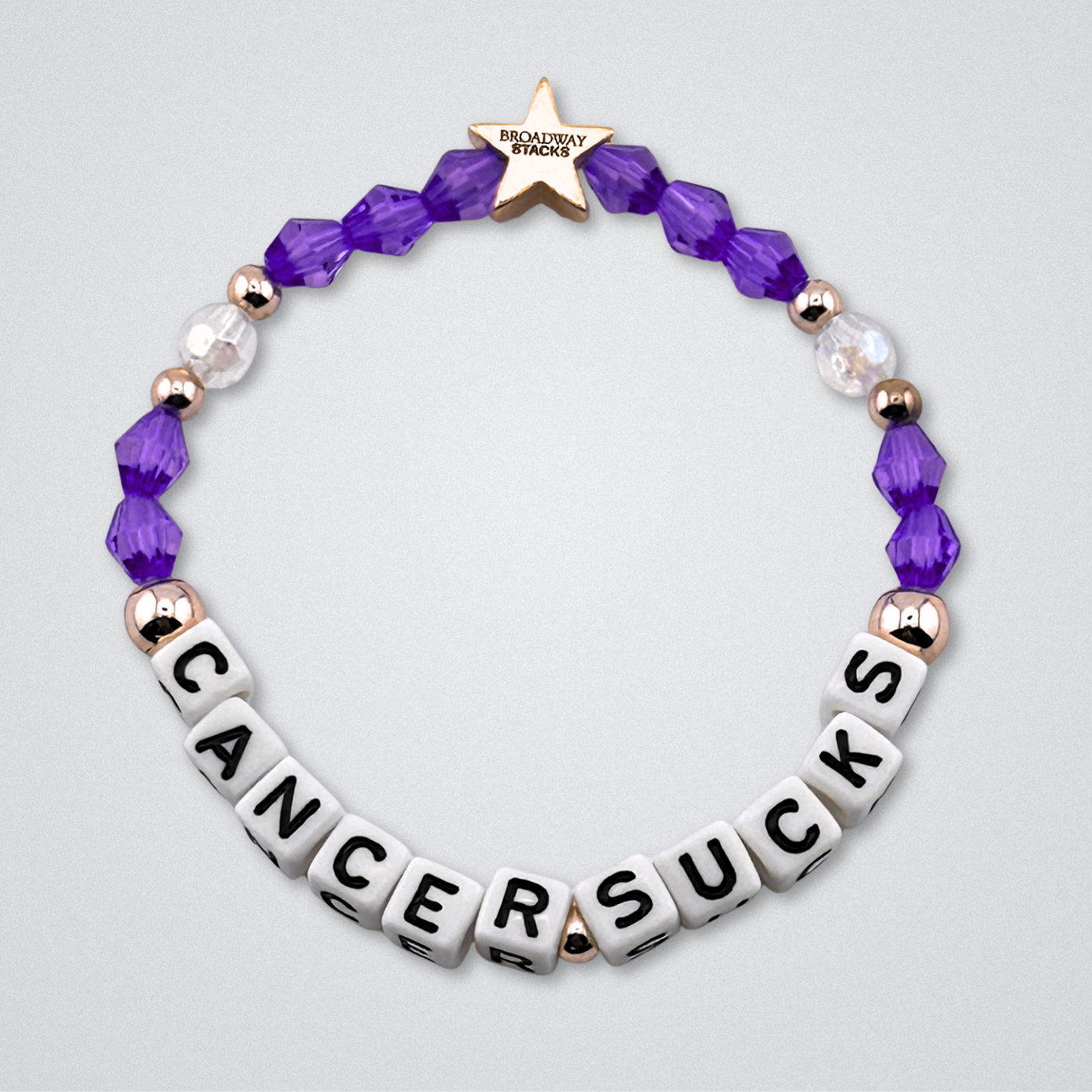 Broadway Stacks Special Edition bracelet. Red, pink, orange, yellow, green, blue. purple, white and gold beads. Letter beads that spell Cancer Sucks. Helping the Broadway Husbands and their fight with Lymphoma cancer. Star logo bead to remind you that you shine.