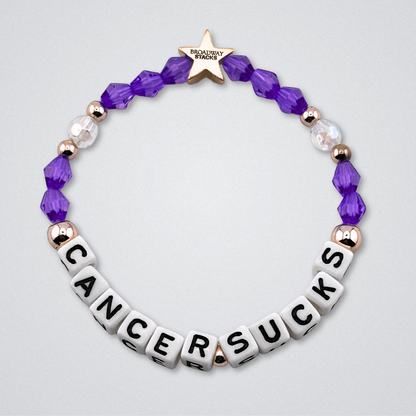 Broadway Stacks Special Edition bracelet. Red, pink, orange, yellow, green, blue. purple, white and gold beads. Letter beads that spell Cancer Sucks. Helping the Broadway Husbands and their fight with Lymphoma cancer. Star logo bead to remind you that you shine.