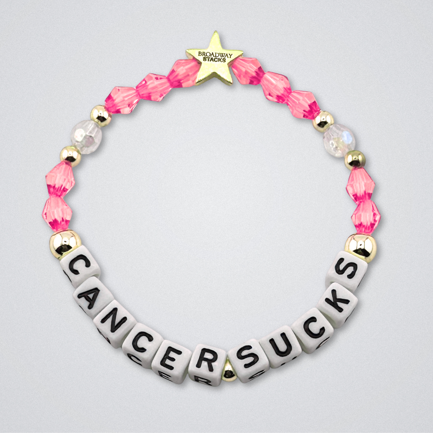 Broadway Stacks Special Edition bracelet. Red, pink, orange, yellow, green, blue. purple, white and gold beads. Letter beads that spell Cancer Sucks. Helping the Broadway Husbands and their fight with Lymphoma cancer. Star logo bead to remind you that you shine.
