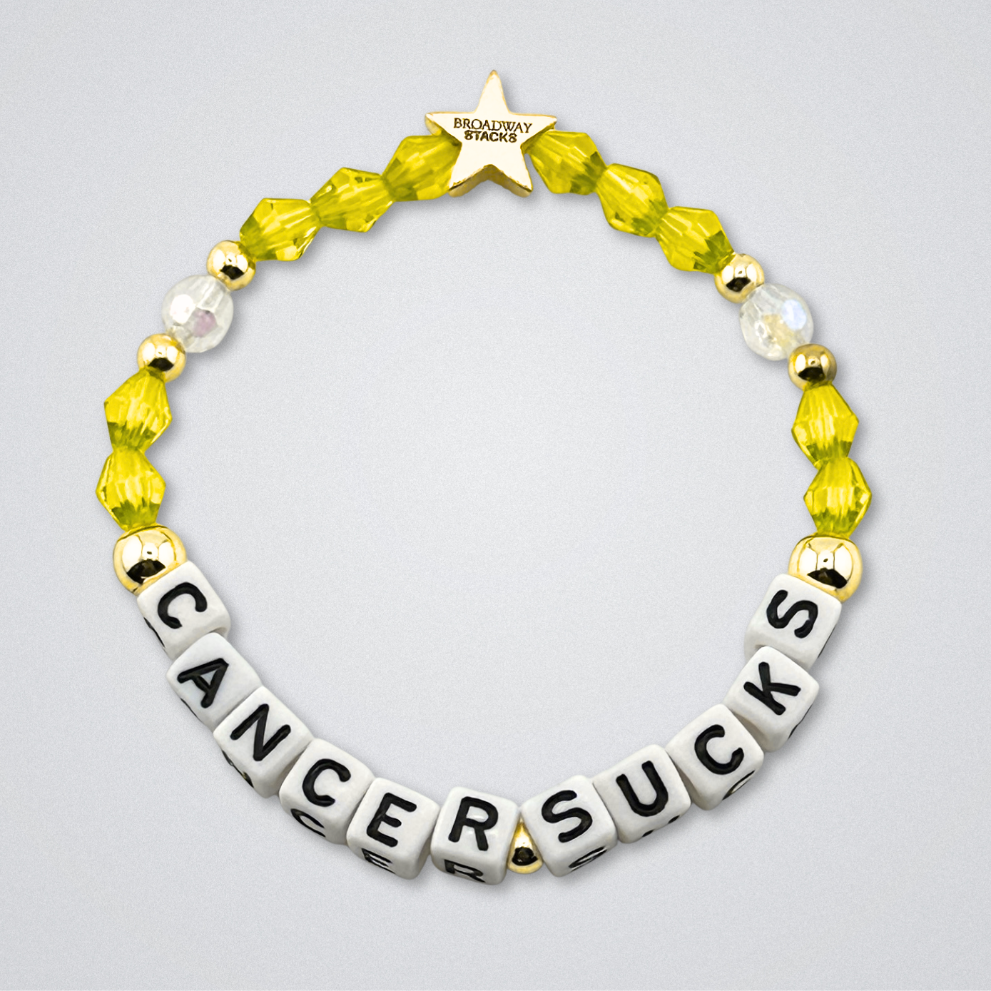 Broadway Stacks Special Edition bracelet. Red, pink, orange, yellow, green, blue. purple, white and gold beads. Letter beads that spell Cancer Sucks. Helping the Broadway Husbands and their fight with Lymphoma cancer. Star logo bead to remind you that you shine.