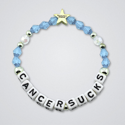 Broadway Stacks Special Edition bracelet. Red, pink, orange, yellow, green, blue. purple, white and gold beads. Letter beads that spell Cancer Sucks. Helping the Broadway Husbands and their fight with Lymphoma cancer. Star logo bead to remind you that you shine.