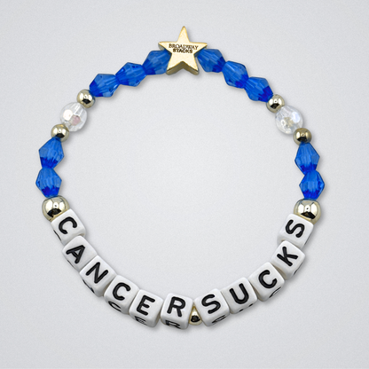 Broadway Stacks Special Edition bracelet. Red, pink, orange, yellow, green, blue. purple, white and gold beads. Letter beads that spell Cancer Sucks. Helping the Broadway Husbands and their fight with Lymphoma cancer. Star logo bead to remind you that you shine.
