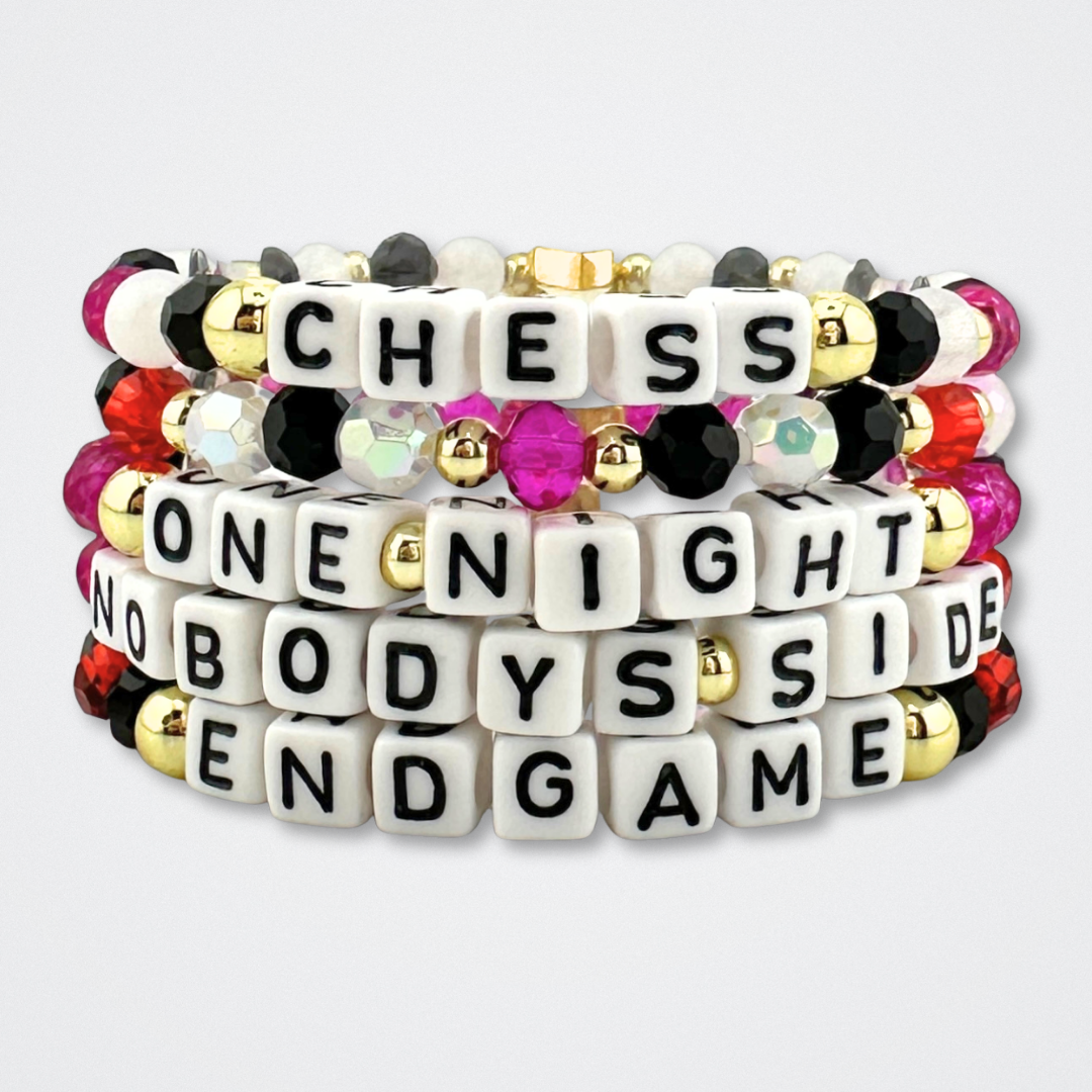 Broadway Stacks CHECKMATE Collection. 5 stretch bracelets included in Stack. Black, white, red, pink and gold colored beads. Letter beads that spell quotes. Star logo bead to remind you that you shine. Chess the Musical fans.