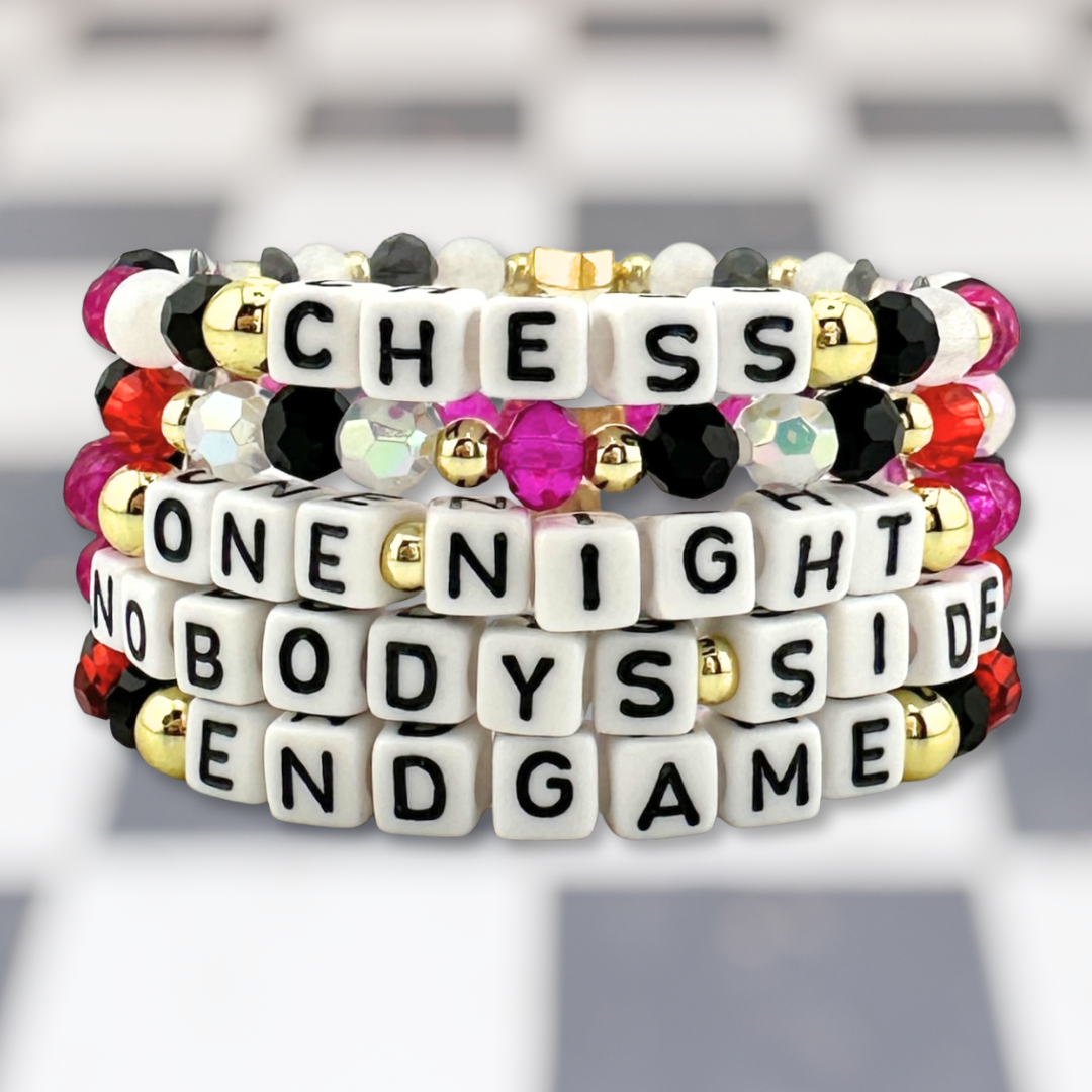 Broadway Stacks CHECKMATE Collection. 5 stretch bracelets included in Stack. Black, white, red, pink and gold colored beads. Letter beads that spell quotes. Star logo bead to remind you that you shine. Chess the Musical fans.