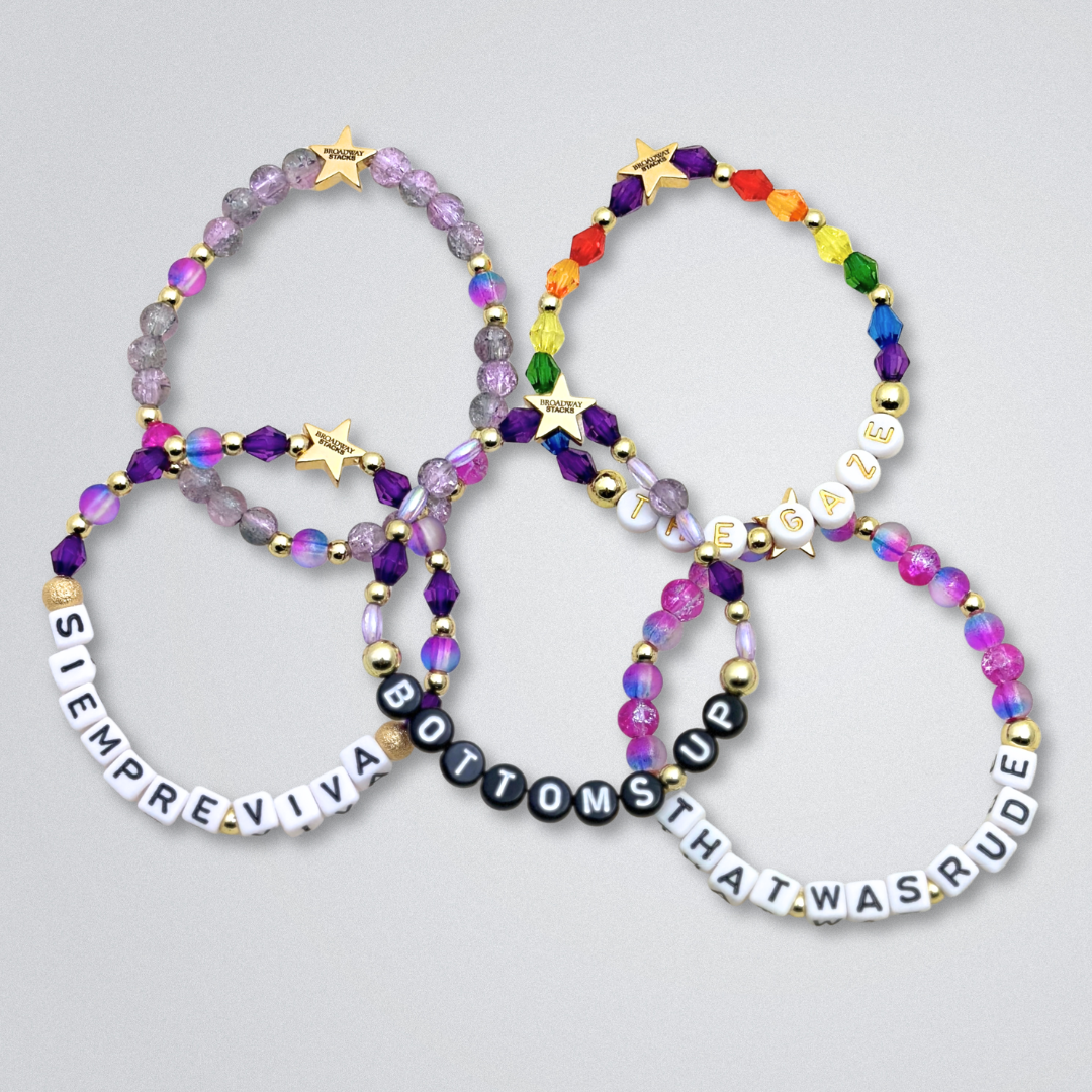 Broadway Stacks SIEMPRE VIVA Collection. 5 stretch bracelets included in Stack. Purple, blue, green, yellow, orange, red and gold colored beads. Letter beads that spell quotes. Gold star logo bead to remind you that you shine. Death Becomes Her fans.
