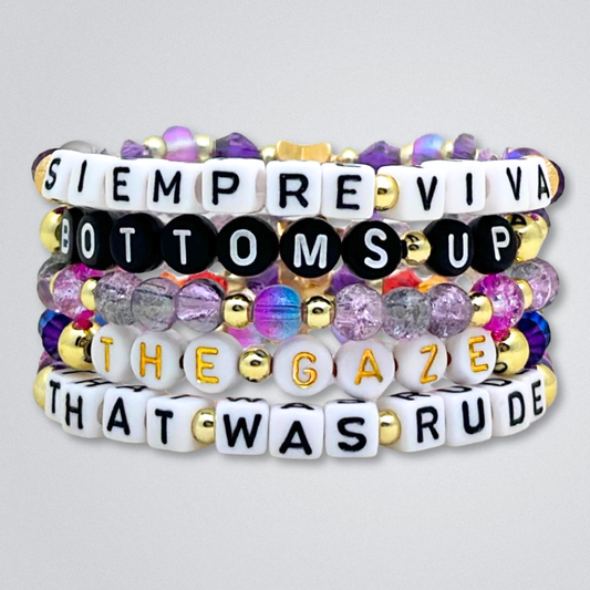 Broadway Stacks SIEMPRE VIVA Collection. 5 stretch bracelets included in Stack. Purple, blue, green, yellow, orange, red and gold colored beads. Letter beads that spell quotes. Gold star logo bead to remind you that you shine. Death Becomes Her fans.