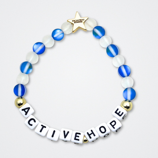 Earth Day Special Edition bracelet. Stack of 3 bracelets. Green, blue, white and gold beads. Letter beads that spell Earth Day 25 and Active Hope. Gold star logo bead to remind you that You Shine.