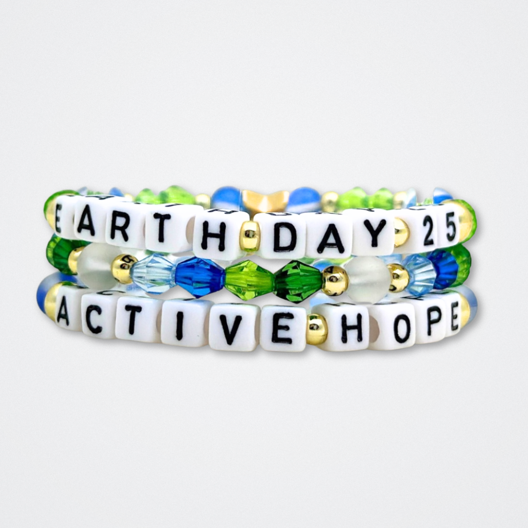 Earth Day Special Edition bracelet. Stack of 3 bracelets. Green, blue, white and gold beads. Letter beads that spell Earth Day 25 and Active Hope. Gold star logo bead to remind you that You Shine.