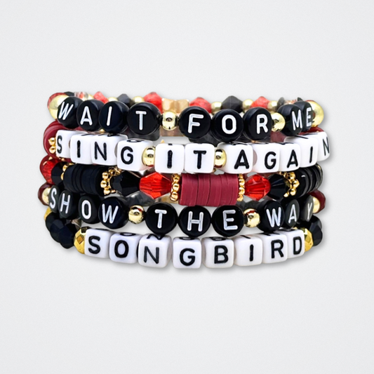 Broadway Stacks UNDERWORLD collection. 5 stretch bracelets included in Stack. Red, garnet, black and gold colored beads. Letter beads that spell quotes. Gold star logo bead to remind you that you shine. Hadestown fans.
