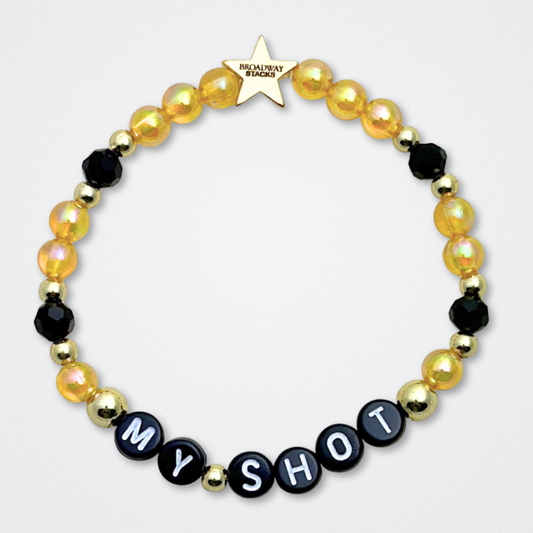 Broadway Stacks REVOLUTION Collection. 5 stretch bracelets included in Stack. Yellow, white, black and gold colored beads. Letter beads that spell quotes. Gold star logo bead to remind you that You Shine. Hamilton the Musical fans. 