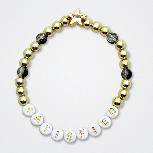 Broadway Stacks REVOLUTION Collection. 5 stretch bracelets included in Stack. Yellow, white, black and gold colored beads. Letter beads that spell quotes. Gold star logo bead to remind you that You Shine. Hamilton the Musical fans. 