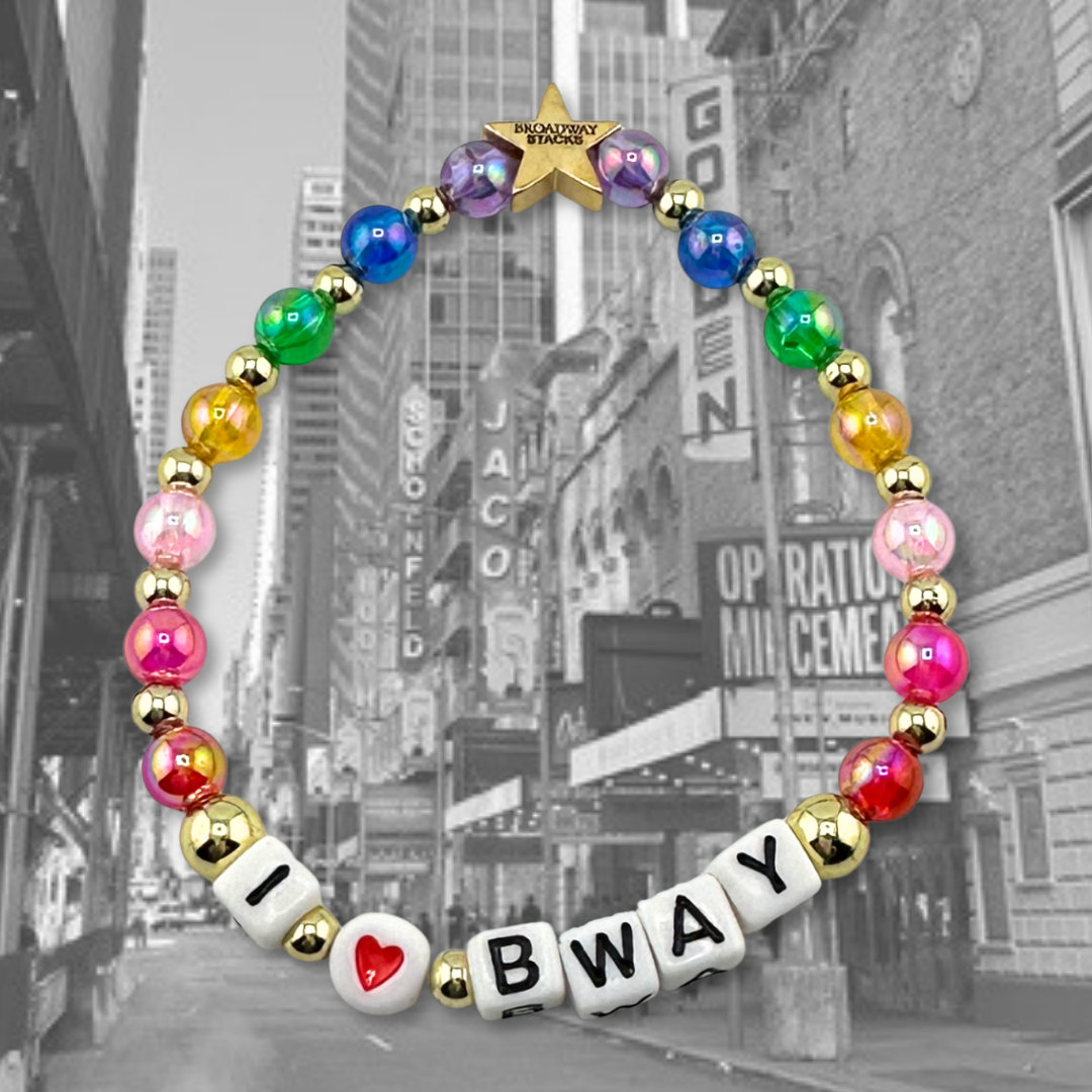 Broadway Stacks I love Bway bead bracelet displayed on a black/white background of the NYC Theatre District. Rainbow color beads. Letter beads spell out quote. Signature star bead to remind you: YOU SHINE! 