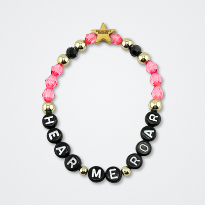 Broadway Stacks De Bois Band collection. Pink, gold and black colored beads on bracelet on gray background. Letter beads that spell quotes. Broadway Stacks gold star logo bead to remind you that you shine. & Juliet the Musical fans.