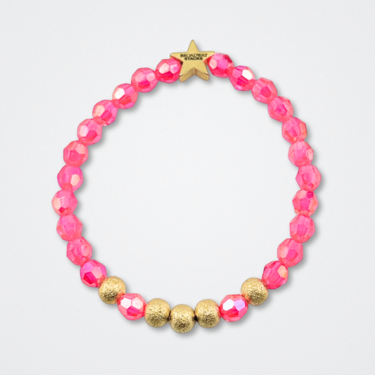Broadway Stacks De Bois Band collection. Pink and gold colored beads on bracelets. Star logo bead to remind you that YOU SHINE! Background is gray. Inspired by & Juliet the Musical.