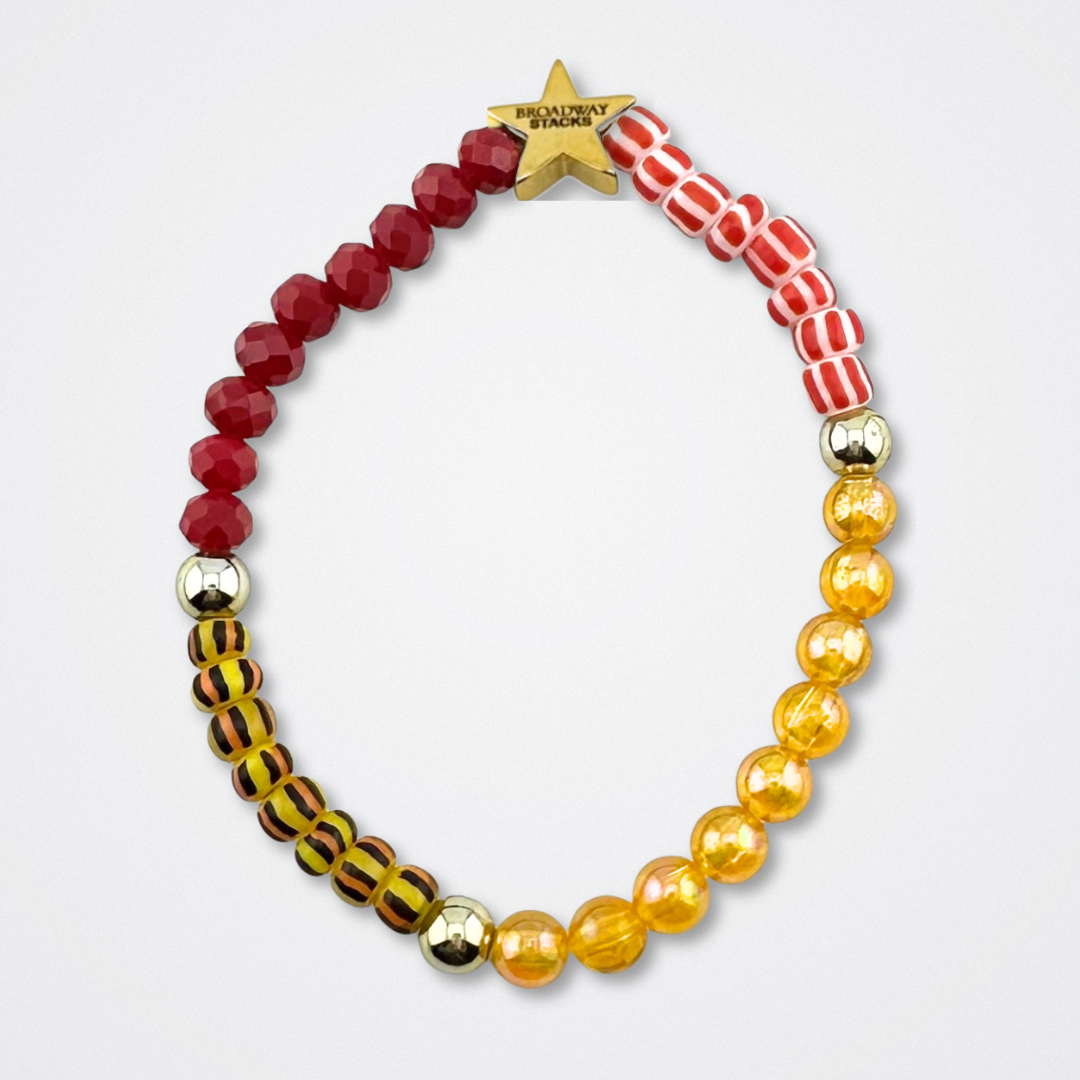 Broadway Stacks SAFARI collection.Yellow, red, animal print and gold colored beads on bracelet on gray background. Star logo bead to remind you that YOU SHINE! The Lion King and theatre fans.
